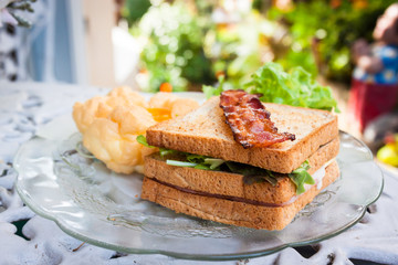 Souffle eggs, bacons and sandwiches in American breakfast on a w