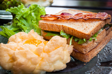 Souffle eggs, bacons and sandwiches in American breakfast on the