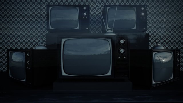 An exhibition of old-fashioned retro color tv sets with tuner antennas.