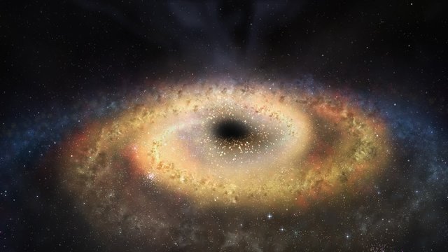 A black hole in the middle of the glowing galaxy consuming the star systems.