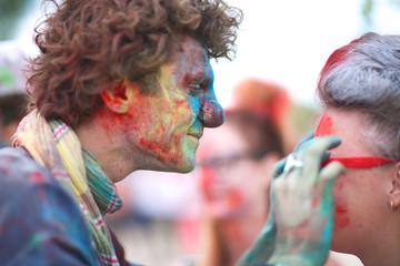 Profile of a clown taking glasses off a woman