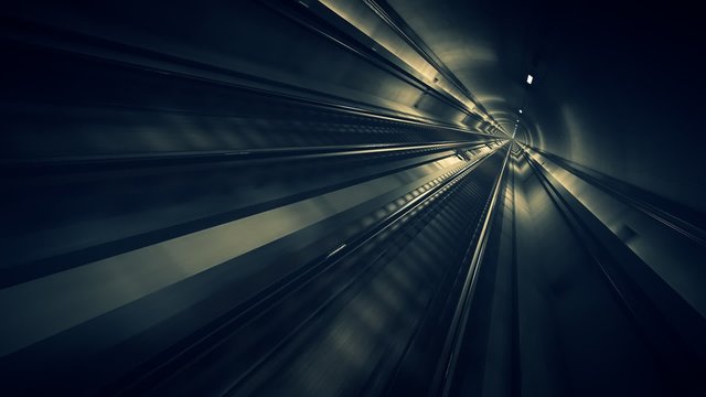 Seamless subway journey through the modern underground empty railway tunnel.