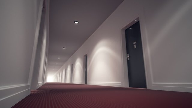 Mystery empty hotel corridor with red carpet, white walls and wooden doors.