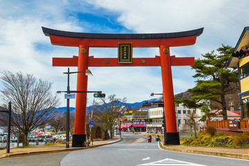 Massive torii gate of Futarasan shrine in front of lake Chuzenji in Nikko, Japan
