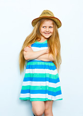 Little blonde girl with long hair posing on white background wi