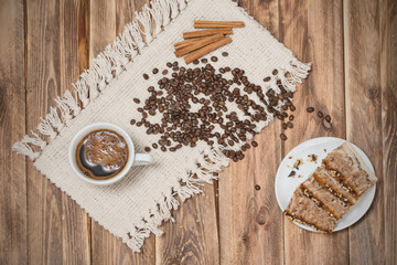cup of coffee with a cinnamon and biscuits