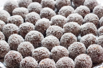 Closeup of coconut balls covered with grated coconut