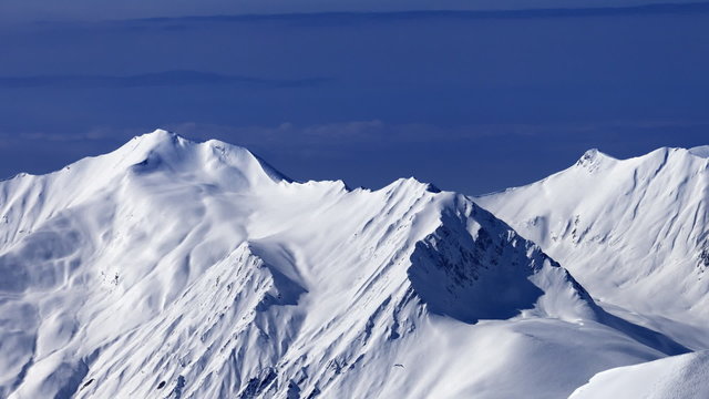 View on off-piste snowy slope at nice day. Caucasus Mountains, Georgia, ski resort Gudauri. 