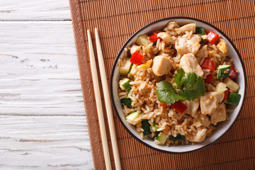 Tyahan - fried rice with chicken and vegetables. Horizontal top view
