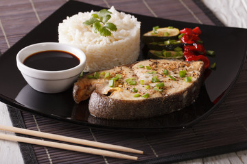 Healthy food: Steak fish, rice and soy sauce close-up. Horizontal
