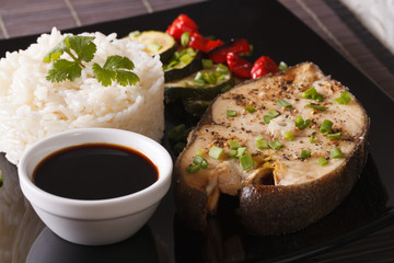 Asian Food: Steak fish, rice and soy sauce close-up. horizontal
