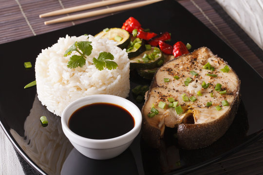 Japanese food: Steak fish and rice close-up on a plate. horizontal

