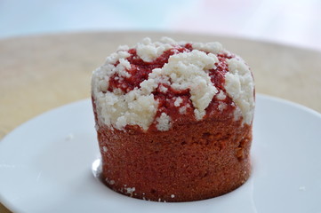 red velvet muffin in paper cup on wooden