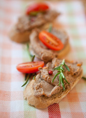 Chicken liver pate on bread with cherry tomatoes  
