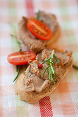 Chicken liver pate on bread with cherry tomatoes  