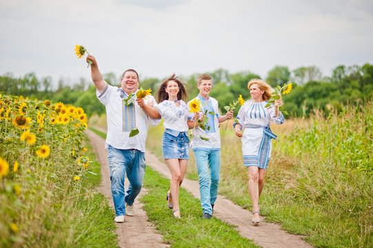 Happy family having fun on sunflowers