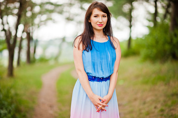 Fototapeta premium Young beautiful and cute girl posed at pine forest