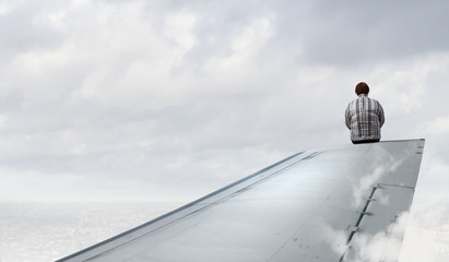 Woman on airplane wing