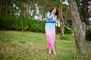 Obraz premium Young beautiful and cute girl posed at pine forest