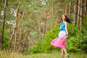 Young beautiful and cute girl posed at pine forest