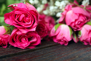 bouquet of roses on wooden table