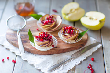 Homemade Apple rose cake on wooden background, selective focus