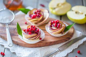 Homemade Apple rose cake on wooden background, selective focus