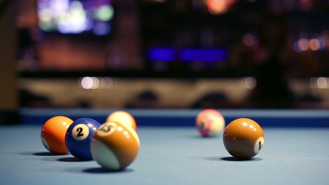Playing Eight-ball pool billiards in a bar