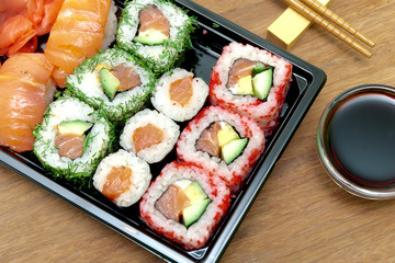  rolls and sushi on a bamboo board close-up.