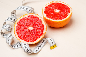 Dieting. Grapefruit with measuring tape