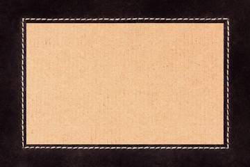 Fototapeta premium Frame of stitched brown suede on cardboard