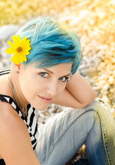 Beautiful girl with blue hairs looking in camera.