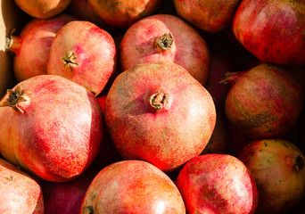 Bright red pomegranate on farm market