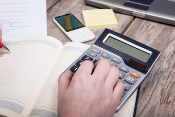  hands of businessman and calculator