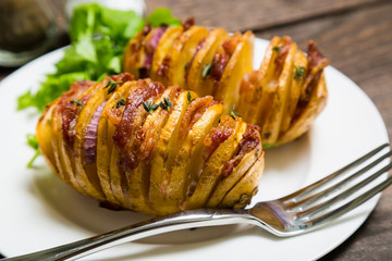 Homemade baked potato with bacon and herbs