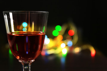 Wine glass with bokeh on dark background