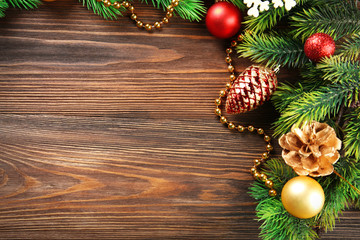 Christmas fir tree branches with toys on wooden table