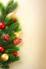 Christmas fir tree branches with toys on paper background