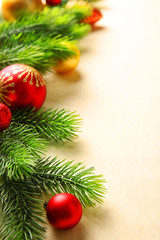 Christmas fir tree branches with toys on paper background