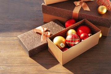 Box with Christmas toys on wooden background