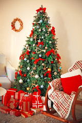 Fototapeta na wymiar Christmas fir tree with gifts in living room