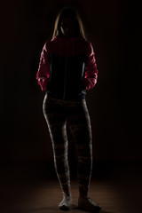 silhouette of a young woman in a jacket