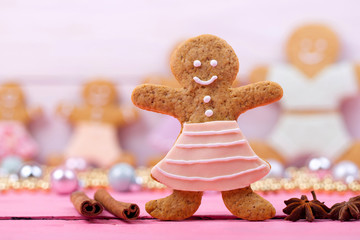 Homemade baked Christmas gingerbread man on vintage wooden backg