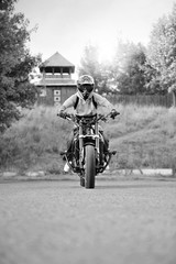 Obraz na płótnie Canvas Wrroom-wrroom. Monochrome soft smudged focus shot of a biker in a helmet read to start racing