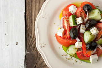 Greek salad on the wooden table top view