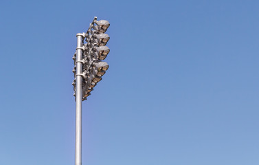 Spotlights soccer stadium with blue sky