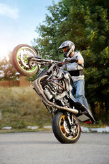 Plakat Feel the adrenaline rush. Extreme biking stunt performer practicing tricks on the road soft smudged focus
