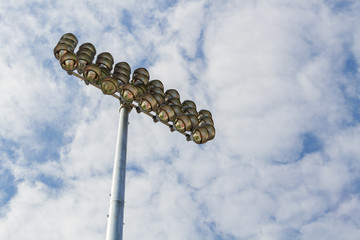 Naklejka premium Spotlights soccer stadium with blue sky