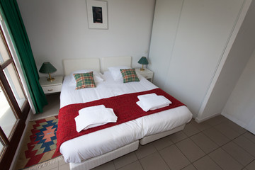 Double Bed In The Bedroom With Desk Lamp Near It