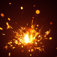 Obraz premium Christmas sparkler in haze with red light